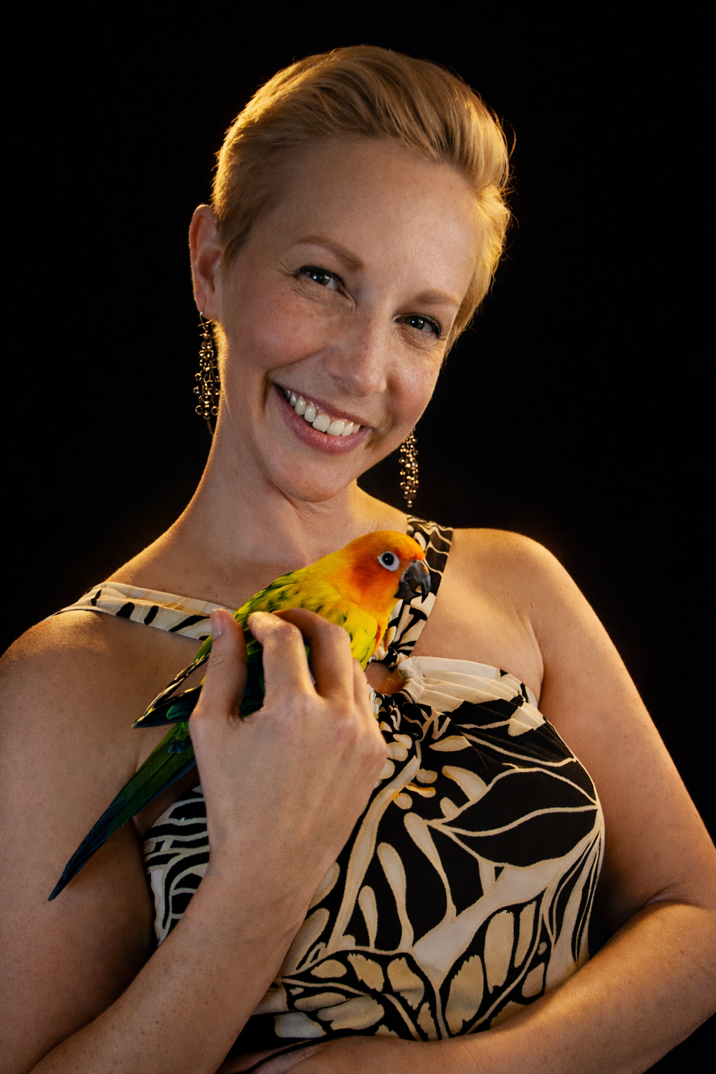 Chris Alyssia holding a colorful bird